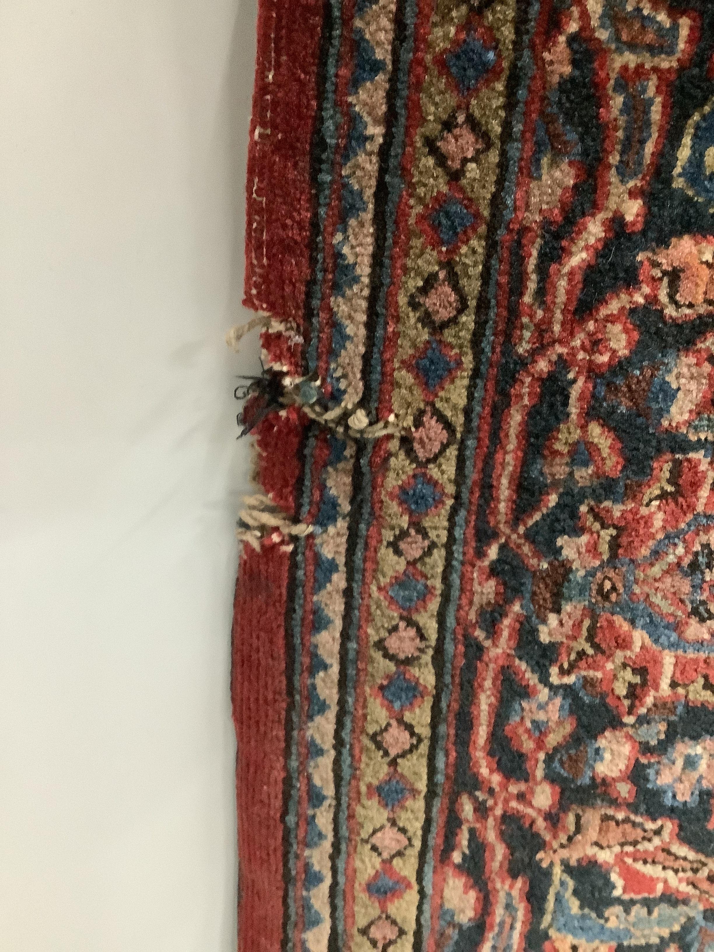 A Tabriz red ground rug, approximately 220 x 136cm